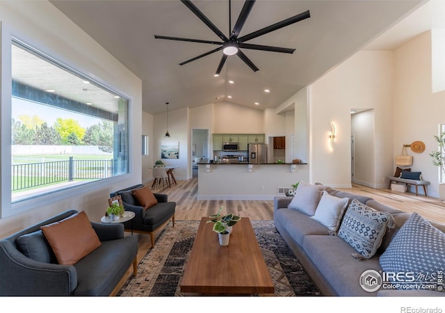 5217 Dry Creek Rd, Evans, CO 80634 - living room featuring a ceiling fan, high vaulted ceiling, light wood-style floors, and recessed lighting