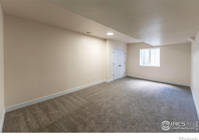 5217 Dry Creek Rd, Evans, CO 80634 - carpeted empty room with baseboards and a textured ceiling
