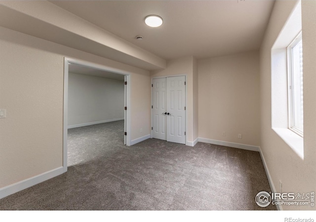 5217 Dry Creek Rd, Evans, CO 80634 - carpeted empty room featuring baseboards and a smoke detector
