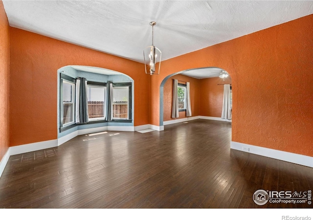 556 Lincoln Ave, Nunn, CO 80648 - spare room featuring a textured wall, arched walkways, and wood-type flooring