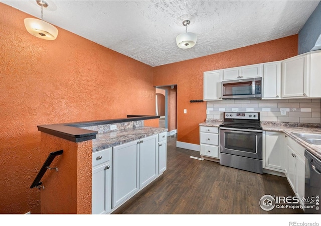 556 Lincoln Ave, Nunn, CO 80648 - kitchen featuring appliances with stainless steel finishes, a textured wall, dark wood-style floors, a textured ceiling, and white cabinetry