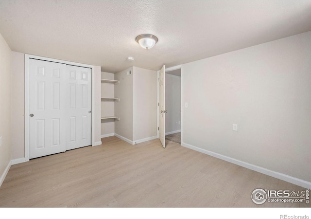556 Lincoln Ave, Nunn, CO 80648 - unfurnished bedroom with wood finished floors, a textured ceiling, and a closet