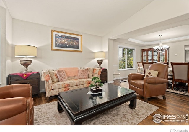 8383 Castaway Dr, Windsor, CO 80528 - living area with a chandelier, wood finished floors, and vaulted ceiling