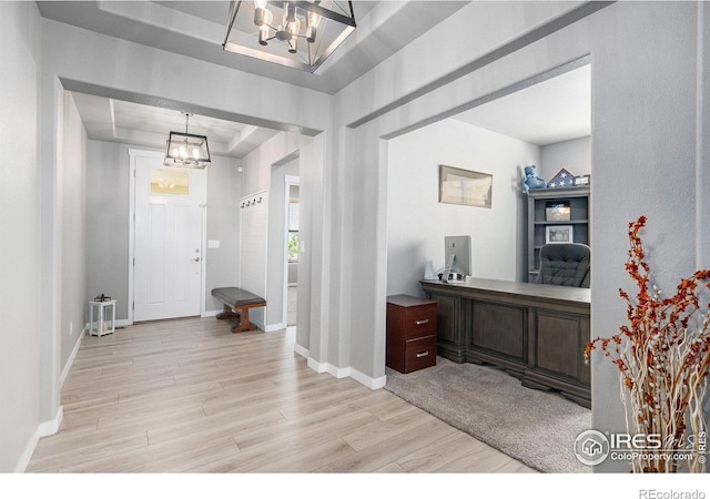 973 Mt Andrew Dr, Severance, CO 80550 - foyer with a raised ceiling, a chandelier, and light wood-style floors
