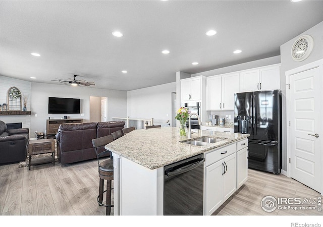 973 Mt Andrew Dr, Severance, CO 80550 - kitchen featuring black appliances, light wood finished floors, recessed lighting, a kitchen island with sink, and a ceiling fan