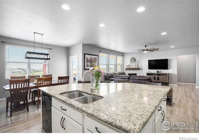 973 Mt Andrew Dr, Severance, CO 80550 - kitchen with recessed lighting, light wood-style floors, an island with sink, ceiling fan, and white cabinetry