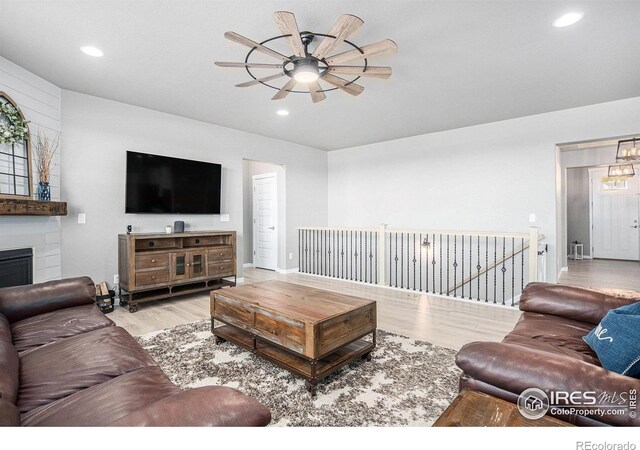 973 Mt Andrew Dr, Severance, CO 80550 - living room with ceiling fan, wood finished floors, recessed lighting, and a fireplace