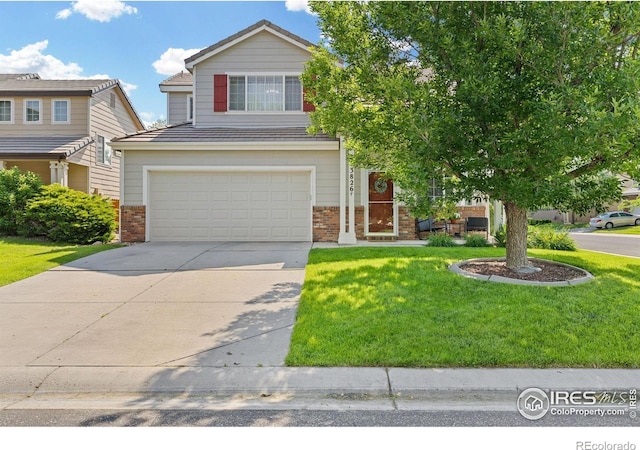 3826 Glenarbor Ln Unit F, Fort Collins, CO 80524 - view of front of home featuring brick siding, a garage, driveway, and a front yard