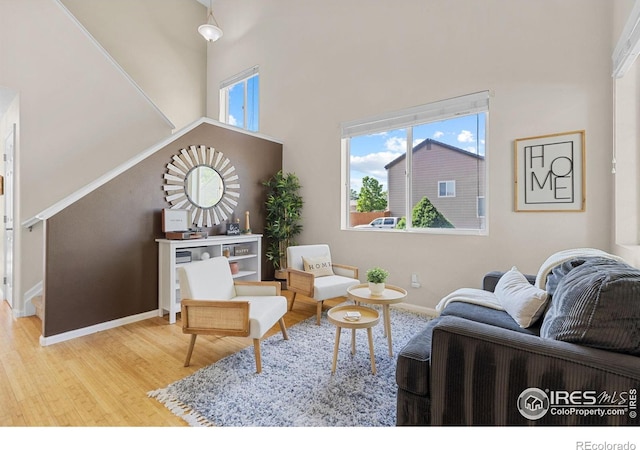 3826 Glenarbor Ln Unit F, Fort Collins, CO 80524 - living area featuring wood finished floors, stairway, and a high ceiling