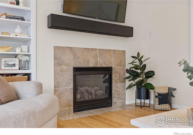 3826 Glenarbor Ln Unit F, Fort Collins, CO 80524 - detailed view of wood finished floors, a tiled fireplace, and built in features