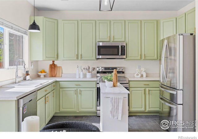 3826 Glenarbor Ln Unit F, Fort Collins, CO 80524 - kitchen with stainless steel appliances, green cabinetry, light countertops, and hanging light fixtures