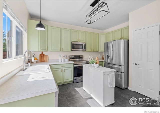 3826 Glenarbor Ln Unit F, Fort Collins, CO 80524 - kitchen with appliances with stainless steel finishes, light countertops, green cabinetry, and a kitchen island