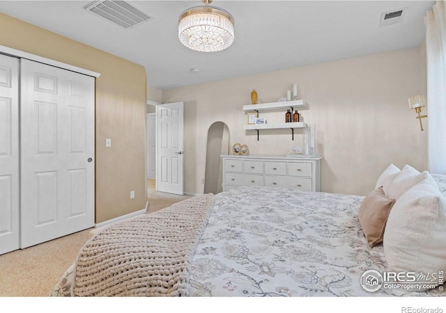 3826 Glenarbor Ln Unit F, Fort Collins, CO 80524 - bedroom featuring light colored carpet, arched walkways, and a chandelier