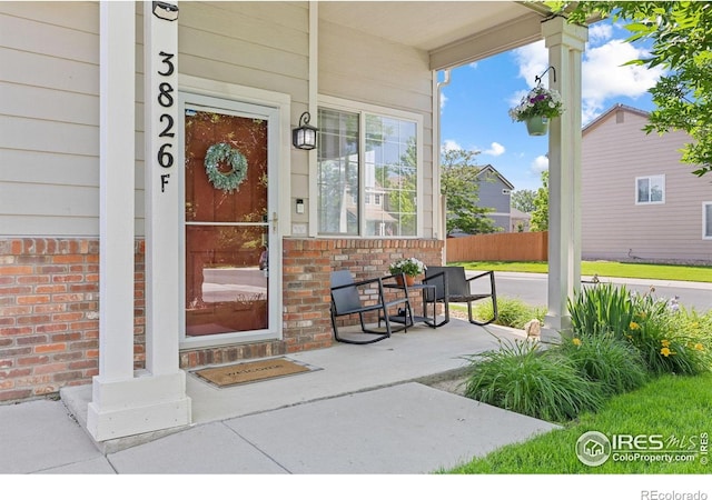 3826 Glenarbor Ln Unit F, Fort Collins, CO 80524 - doorway to property with brick siding and a porch