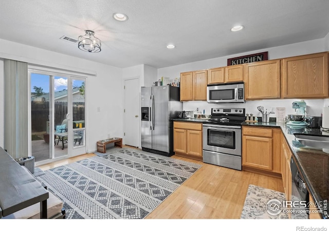 858 Turpin Way, Erie, CO 80516 - kitchen featuring stainless steel appliances, light wood-type flooring, recessed lighting, and dark countertops
