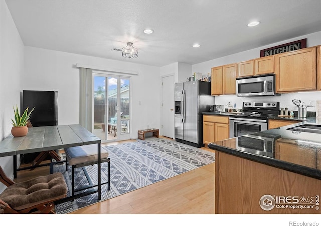 858 Turpin Way, Erie, CO 80516 - kitchen with stainless steel appliances, dark countertops, light wood-type flooring, recessed lighting, and light brown cabinets