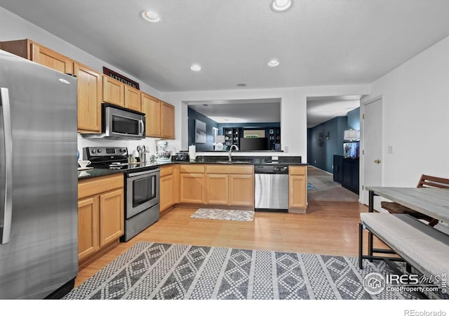 858 Turpin Way, Erie, CO 80516 - kitchen featuring stainless steel appliances, dark countertops, light wood finished floors, light brown cabinetry, and recessed lighting