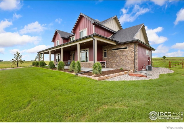 9260 Meadow Farms Dr, Milliken, CO 80543 - view of property exterior with board and batten siding, stone siding, and a patio