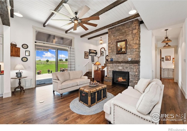 9260 Meadow Farms Dr, Milliken, CO 80543 - living room with wood finished floors, ceiling fan, a fireplace, a wooden ceiling with exposed beams, and stairs