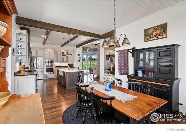 9260 Meadow Farms Dr, Milliken, CO 80543 - dining room featuring dark wood-style flooring and beam ceiling