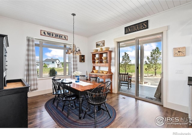 9260 Meadow Farms Dr, Milliken, CO 80543 - dining area featuring plenty of natural light, crown molding, dark wood finished floors, a chandelier, and wooden ceiling