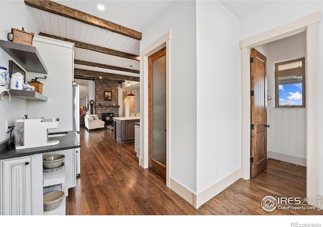 9260 Meadow Farms Dr, Milliken, CO 80543 - hallway featuring dark wood-style flooring and a wood ceiling with exposed beams