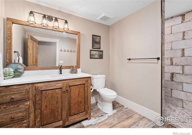9260 Meadow Farms Dr, Milliken, CO 80543 - bathroom featuring wood finished floors, vanity, and a tile shower