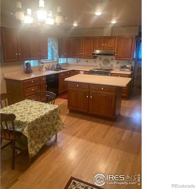 14751 E 24th Ave, Aurora, CO 80011 - kitchen featuring black dishwasher, under cabinet range hood, light countertops, and light wood-style floors