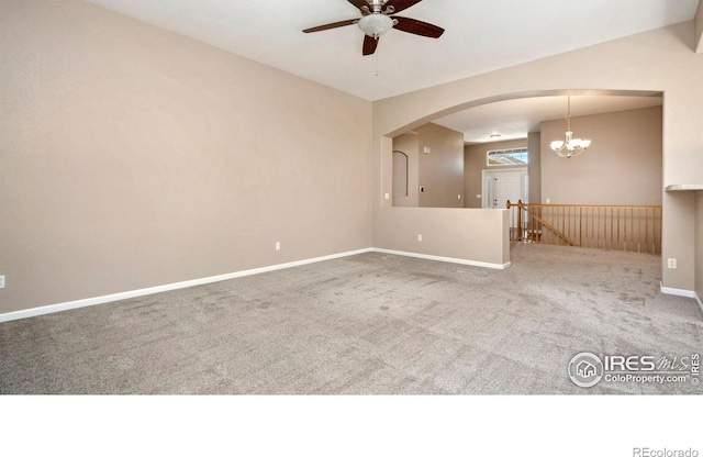 3664 Claycomb Ln, Johnstown, CO 80534 - carpeted spare room featuring a ceiling fan, arched walkways, and a chandelier