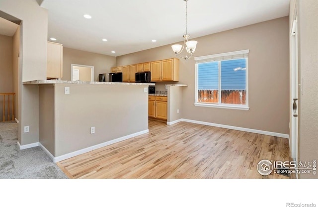 3664 Claycomb Ln, Johnstown, CO 80534 - kitchen featuring freestanding refrigerator, light brown cabinets, black microwave, a chandelier, and recessed lighting
