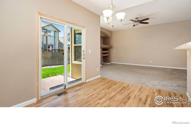 3664 Claycomb Ln, Johnstown, CO 80534 - unfurnished room with a chandelier, wood finished floors, and ceiling fan