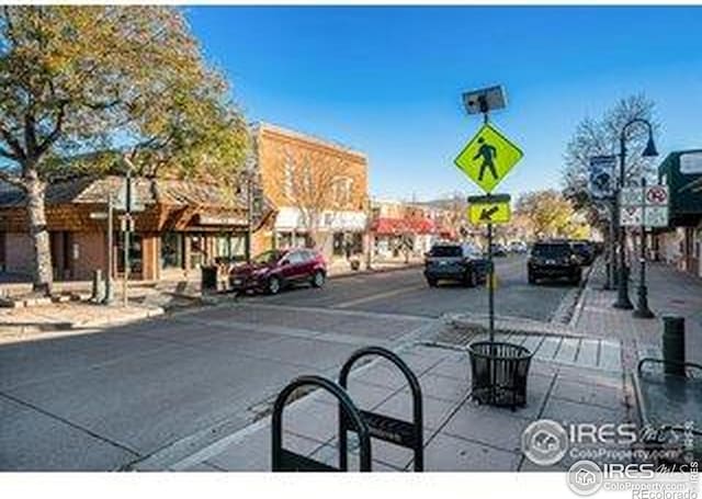 3664 Claycomb Ln, Johnstown, CO 80534 - view of asphalt road with sidewalks, traffic signs, and curbs