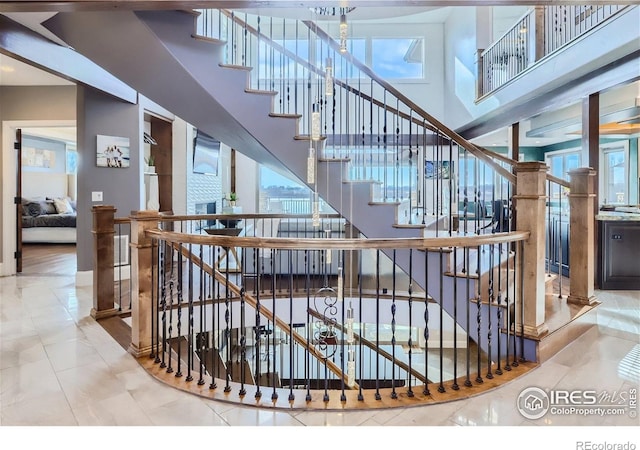 5763 Pelican Shores Dr, Longmont, CO 80504 - staircase featuring a towering ceiling