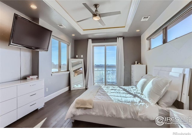 5763 Pelican Shores Dr, Longmont, CO 80504 - bedroom featuring a raised ceiling, multiple windows, access to exterior, dark wood-style floors, and recessed lighting