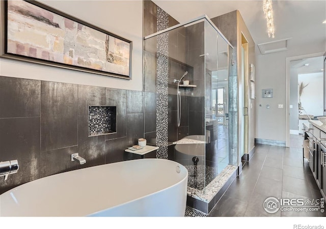 5763 Pelican Shores Dr, Longmont, CO 80504 - bathroom featuring a freestanding bath, a shower stall, tile patterned flooring, and vanity