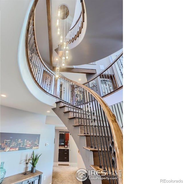 5763 Pelican Shores Dr, Longmont, CO 80504 - stairs featuring a towering ceiling and carpet floors