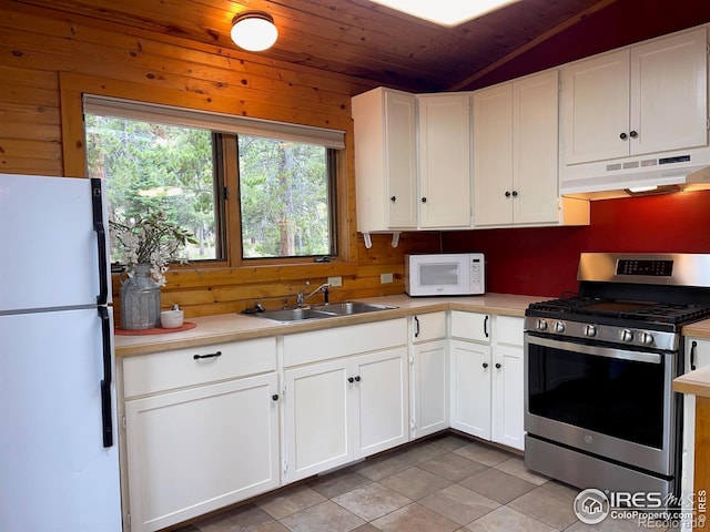 33 N Skinner Rd, Allenspark, CO 80510 - kitchen with white appliances, under cabinet range hood, wooden ceiling, healthy amount of natural light, and light countertops