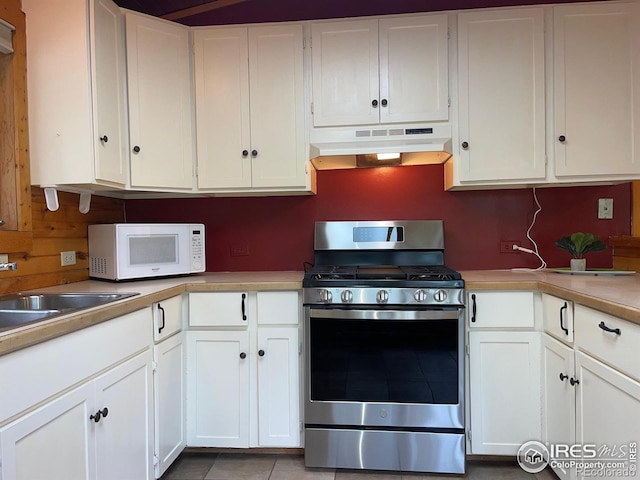 33 N Skinner Rd, Allenspark, CO 80510 - kitchen featuring gas stove, under cabinet range hood, white microwave, and white cabinets
