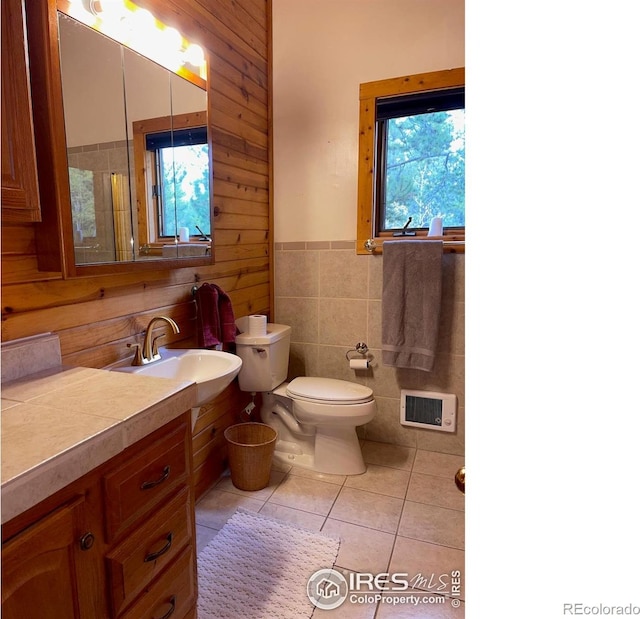 33 N Skinner Rd, Allenspark, CO 80510 - full bathroom with tile patterned flooring, vanity, a wainscoted wall, tile walls, and wood walls