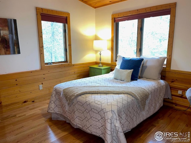 33 N Skinner Rd, Allenspark, CO 80510 - bedroom with wainscoting, wood finished floors, and wooden walls