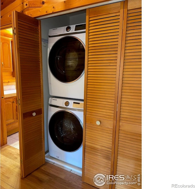 33 N Skinner Rd, Allenspark, CO 80510 - laundry room with estacked washer and dryer and wood finished floors
