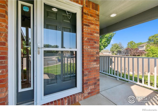 1204 Boulder Ct, Windsor, CO 80550 - doorway to property with covered porch and brick siding