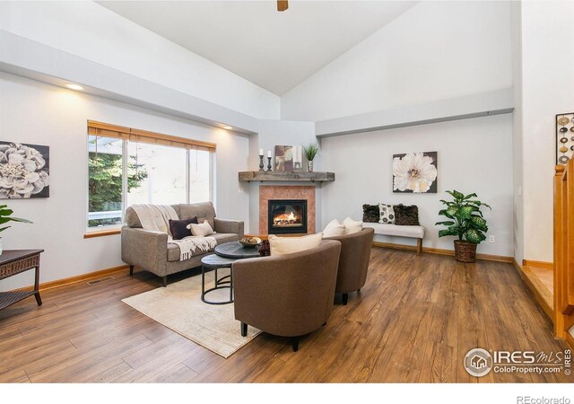 1204 Boulder Ct, Windsor, CO 80550 - living room featuring wood-type flooring, a fireplace, and high vaulted ceiling