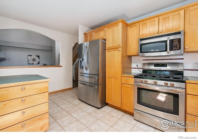 1204 Boulder Ct, Windsor, CO 80550 - kitchen with stainless steel appliances, light tile patterned floors, and tasteful backsplash