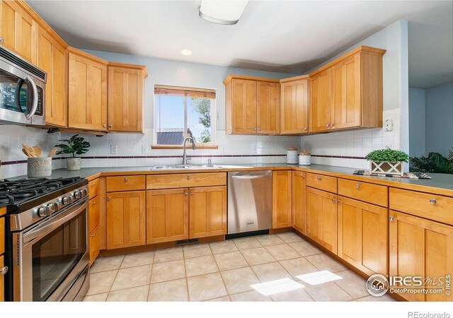1204 Boulder Ct, Windsor, CO 80550 - kitchen with stainless steel appliances, backsplash, light tile patterned flooring, and recessed lighting