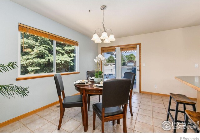 1204 Boulder Ct, Windsor, CO 80550 - dining area featuring a chandelier and light tile patterned floors