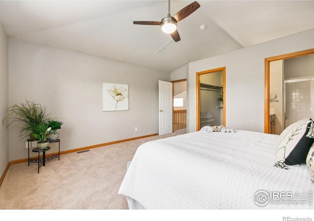 1204 Boulder Ct, Windsor, CO 80550 - bedroom with carpet floors, lofted ceiling, a walk in closet, connected bathroom, and a ceiling fan