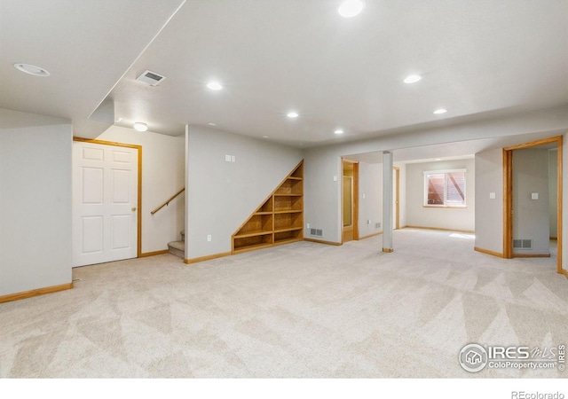 1204 Boulder Ct, Windsor, CO 80550 - finished basement with recessed lighting, carpet, and stairway