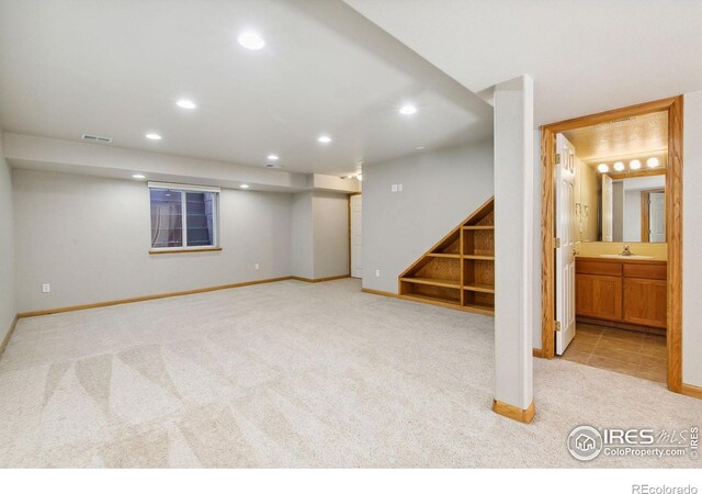 1204 Boulder Ct, Windsor, CO 80550 - finished basement featuring light colored carpet, recessed lighting, and stairway