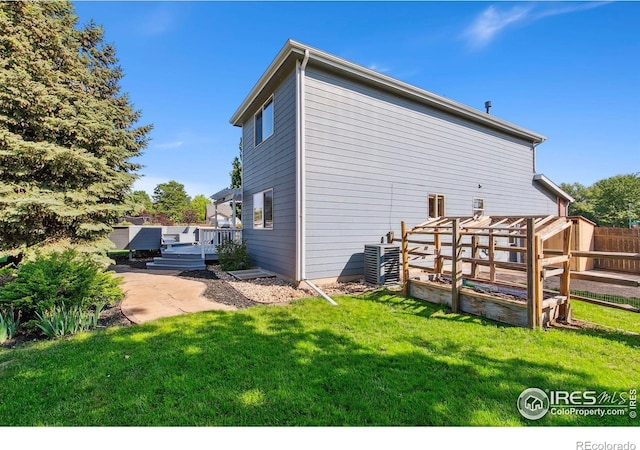 1204 Boulder Ct, Windsor, CO 80550 - back of property featuring a wooden deck